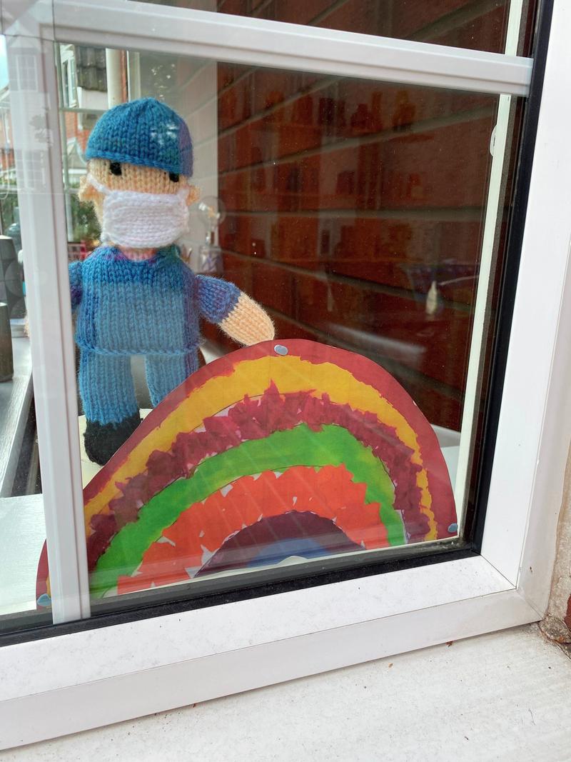 Knitted doctor in window