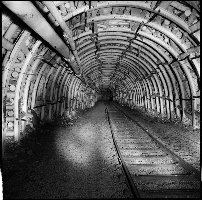 Black and white film negative showing an underground roadway, Cwmtillery Colliery 22 November 1977.  'Cwmtillery, 22 November 1977' is transcribed from original negative bag.
