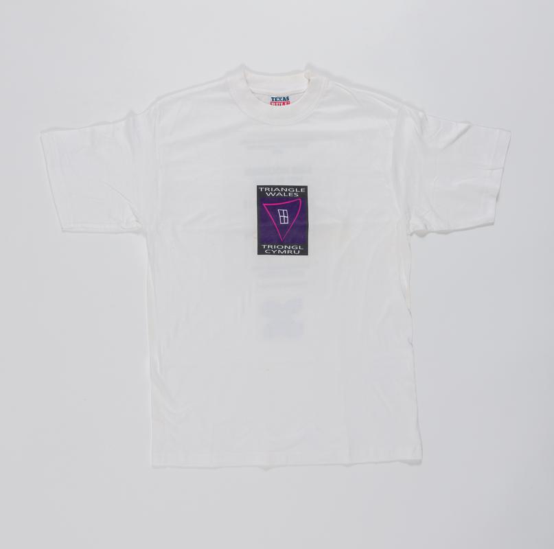 White t-shirt with 'Triangle Wales / Triongl Cymru' logo on the front. On the back is printed information on the LGB Housing Helpline that was launched on the 22 June 2004.