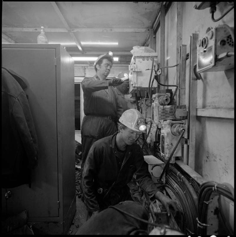Black and white film negative showing men carrying out maintenance work, Lady Windsor Colliery