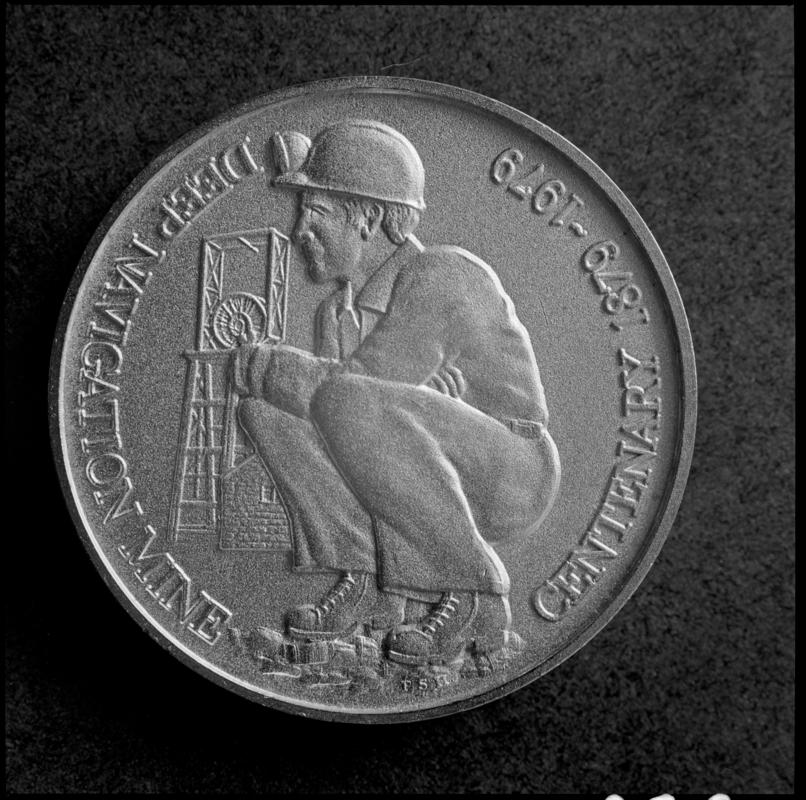 Black and white film negative showing a medallion commemorating the centenary anniversary of Deep Navigation Colliery, 1879-1979.