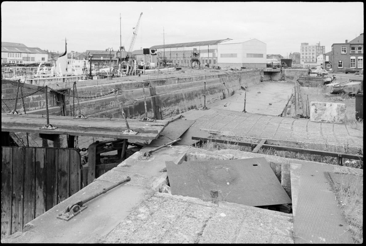 View of the disused Mountstuart Dry Docks, with a dock gate in foreground.