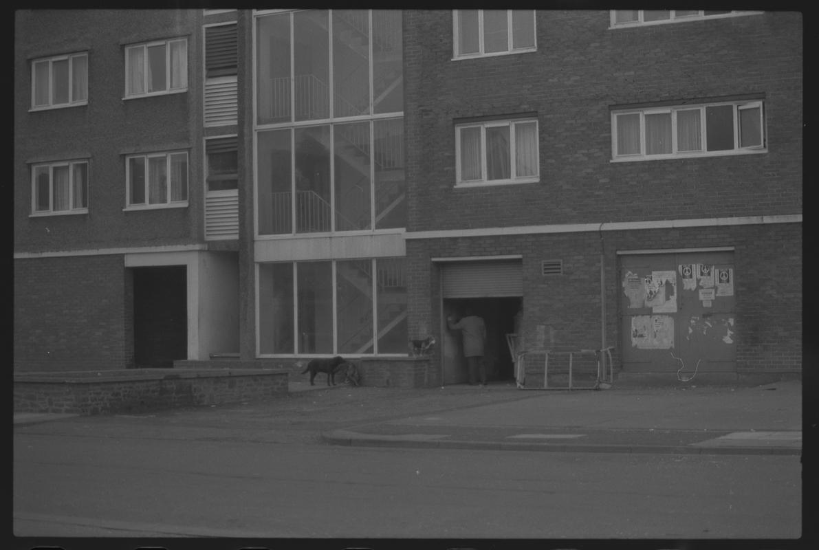 View of bottom three stories of flats in Loudoun Square, Butetown showing doorways and staircases.