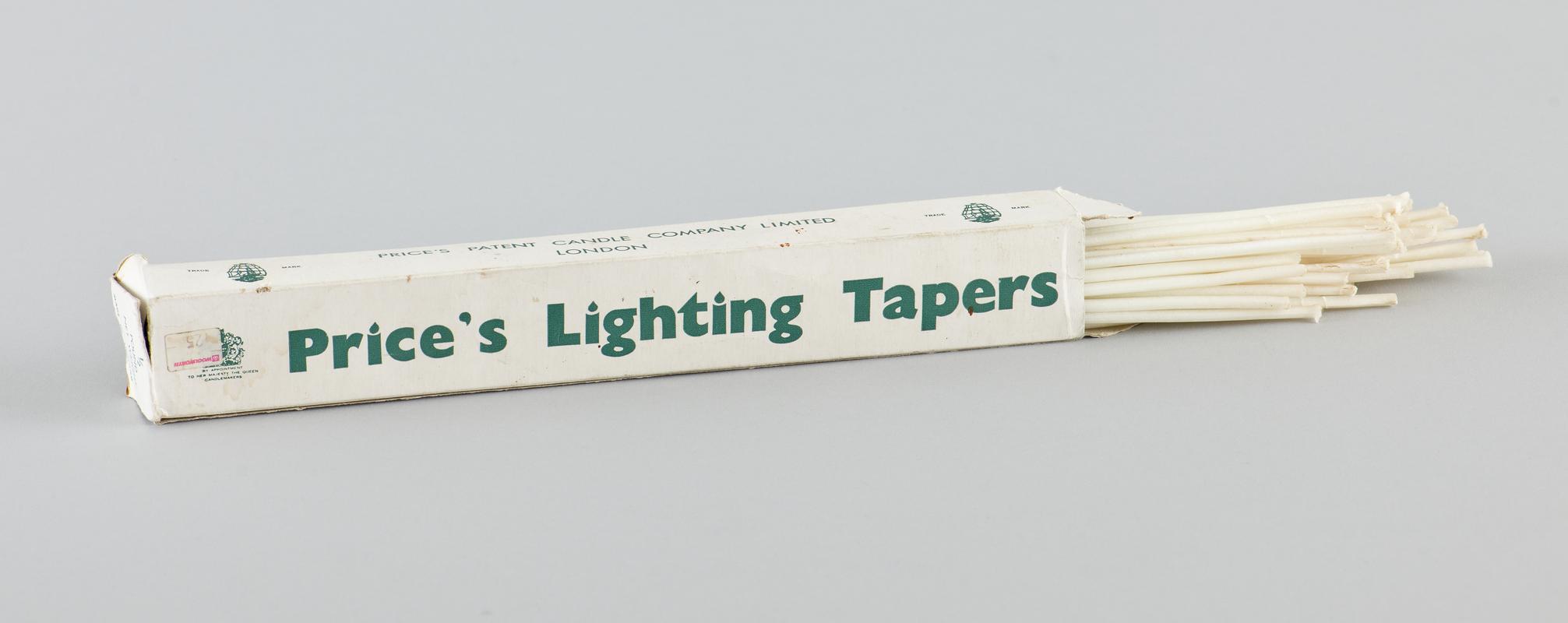 Half pound box of 'Prices' wax lighting tapers in original card box. White card with green printed branding, well worn with flap missing from one end. Some of the wax tapers have been removed from box, which is about 75% full.
