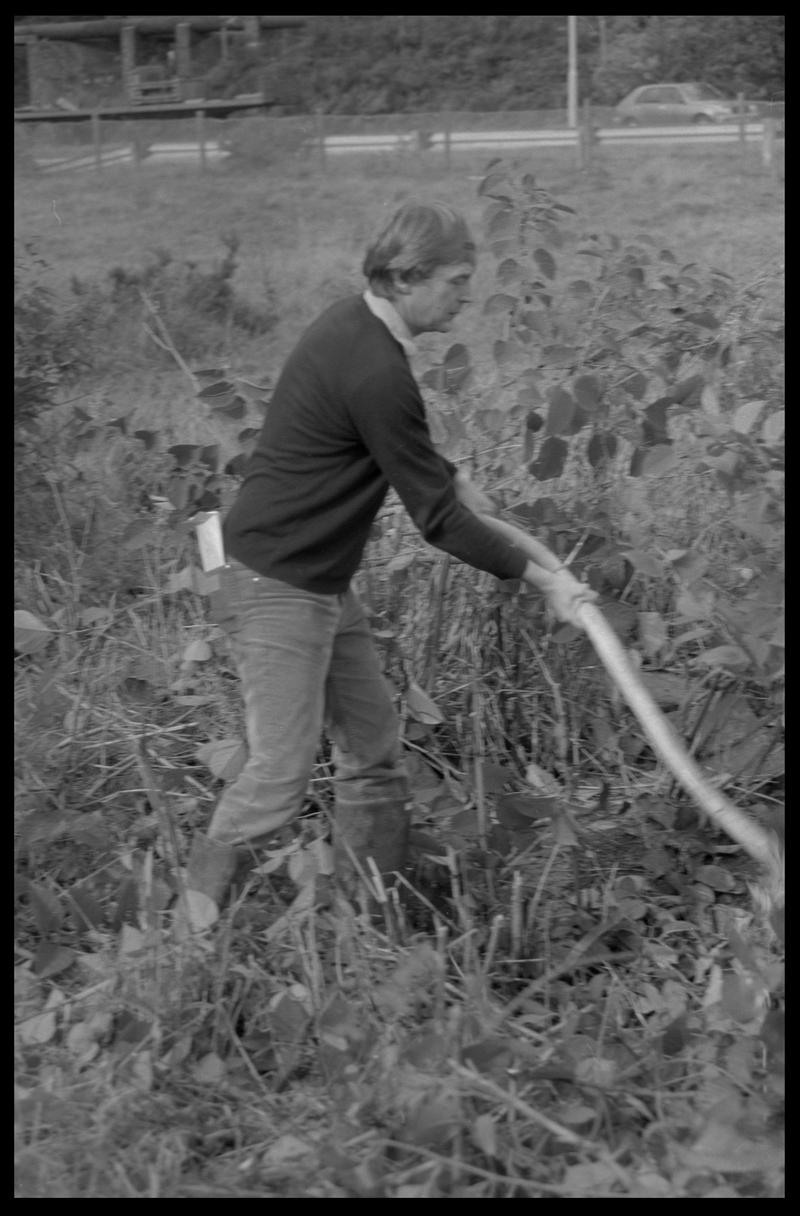 Man with scythe, possibly a volunteer with Canal Society. Location unknown.