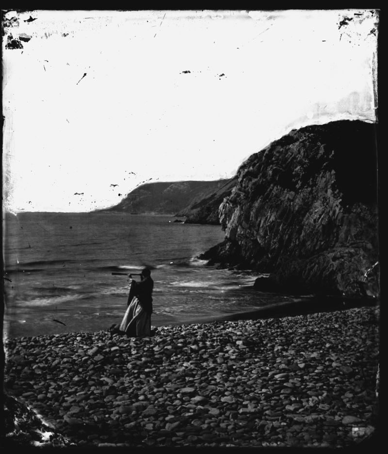 Thereza at Caswell Bay with telescope, glass neg