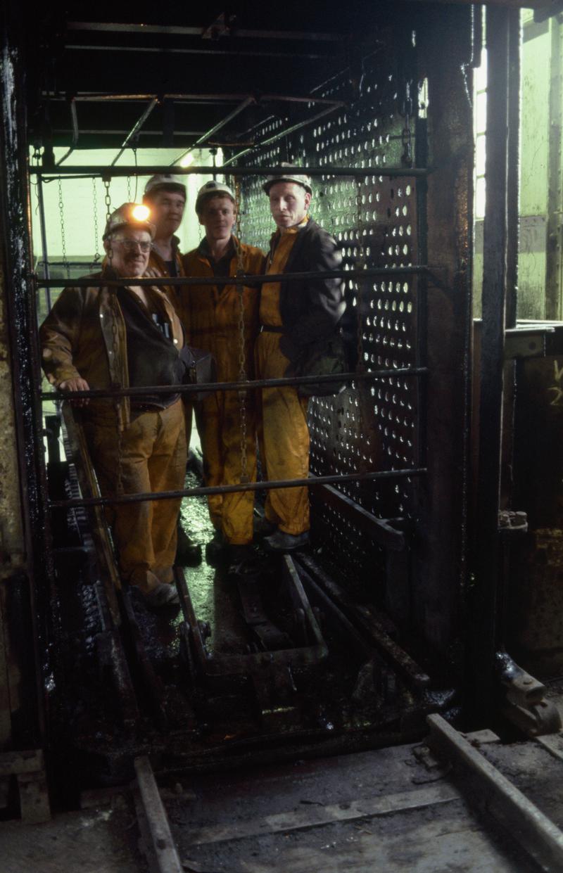 Colour film slide showing miners in cage at pit top, Oakdale Colliery 21 May 1981.