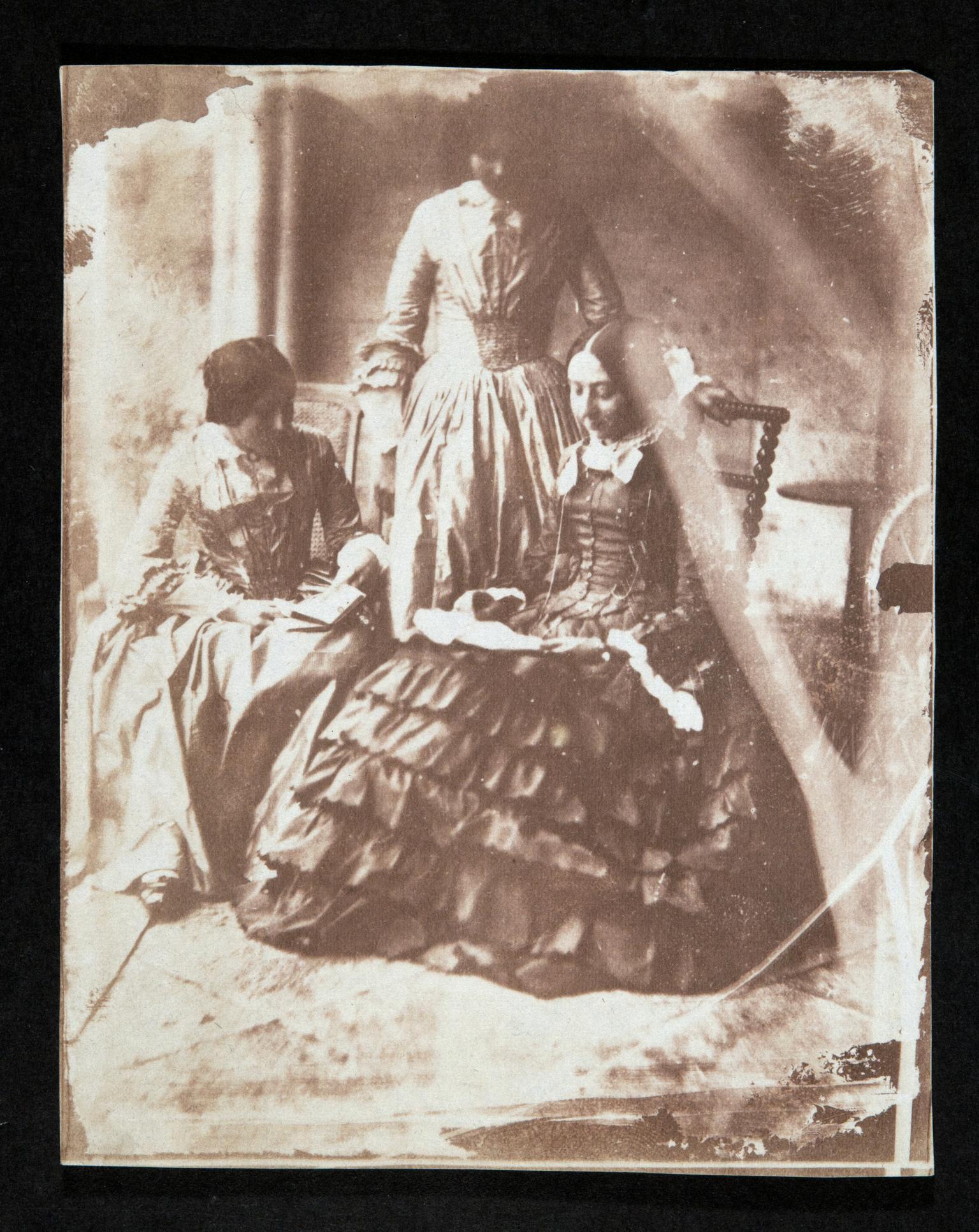 Three ladies reading, photograph