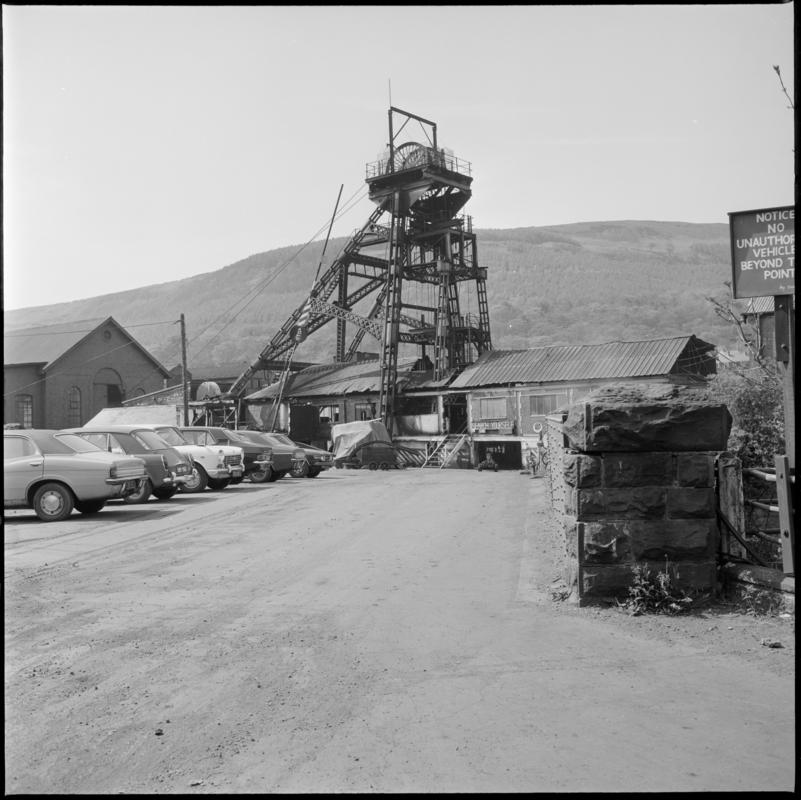 Black and white film negative showing the downcast headgear and Deep Duffryn Colliery carpark, 19 May 1977.  'Deep Duffryn 19/5/77' is transcribed from original negative bag.