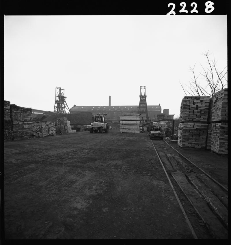 Black and white film negative showing a view of the upcast and downcast shaft, taken from Penallta Colliery yard, 9 April 1981.