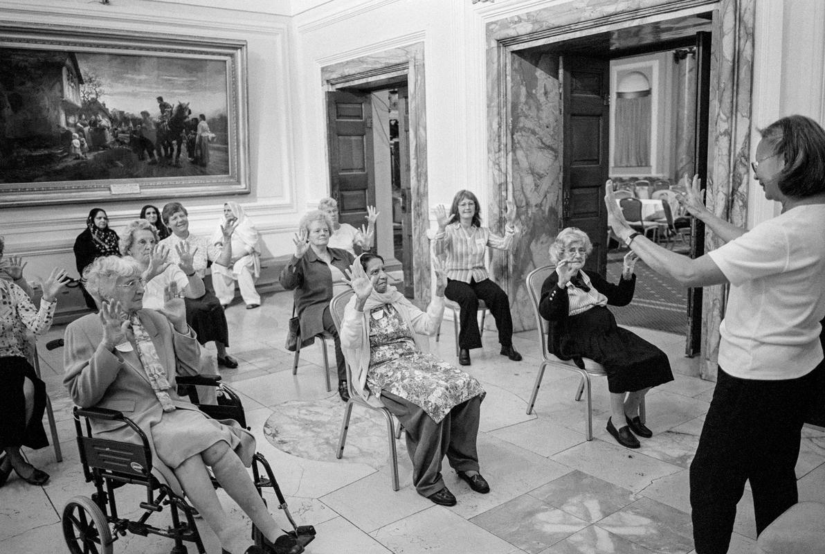 GB. WALES. Cardiff. Exercise class at Older Persons Congress. City Hall. 2004.