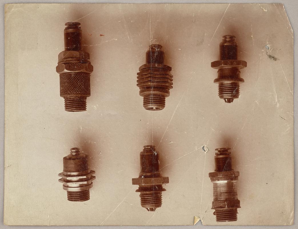 Photograph of six spark plugs.
