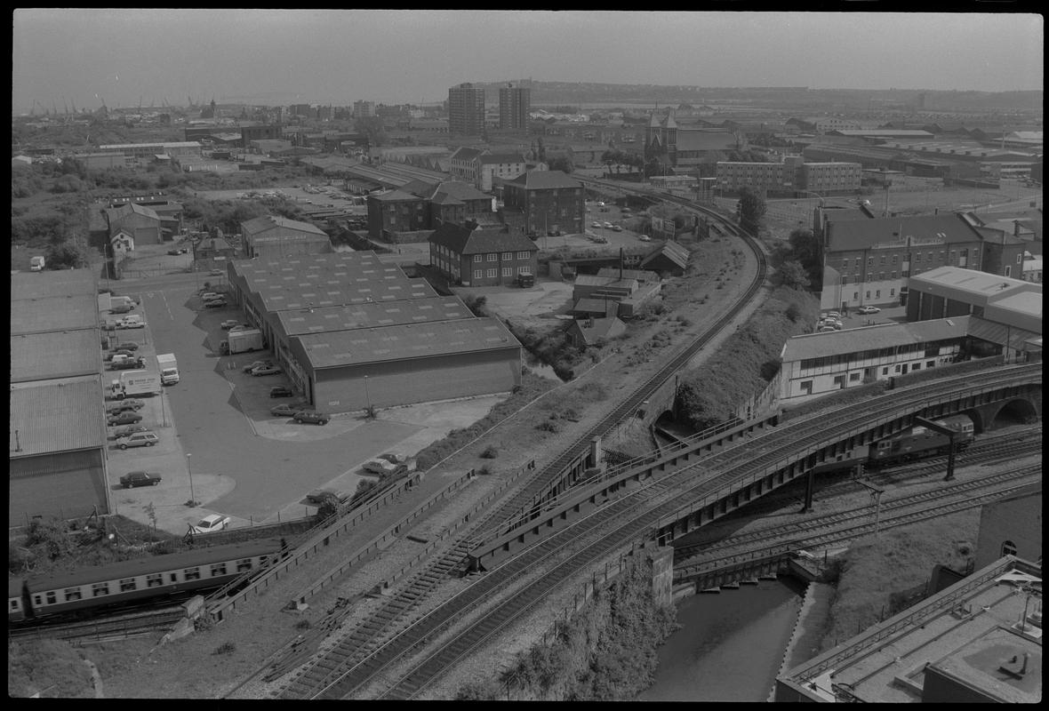 View of Butetown, with railway junction for Bute Road and docks feeder in foreground, and Penarth Head with Loudoun Square Flats in background.