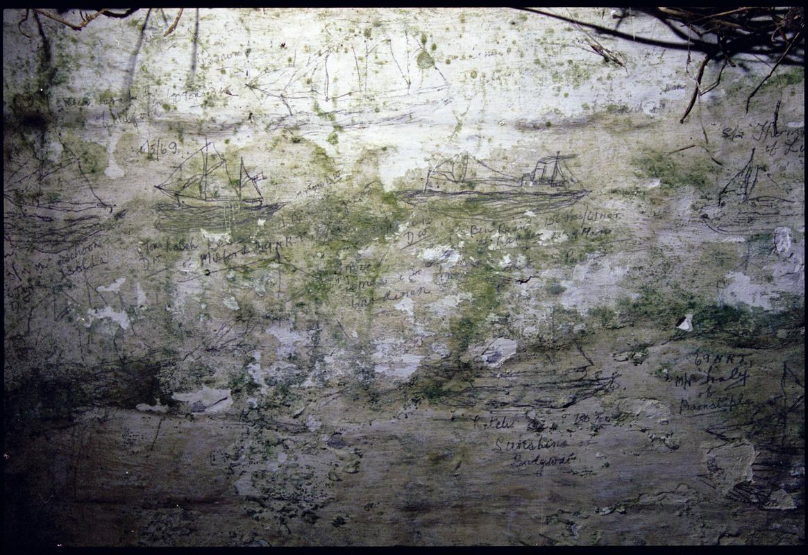 Graffitied ty bach in a garden in Trefin, Pembrokeshire. The plaster of the interior is covered with charcoal drawings of various vessels, with details of tonnage, routes and crew, and date back to 1911.