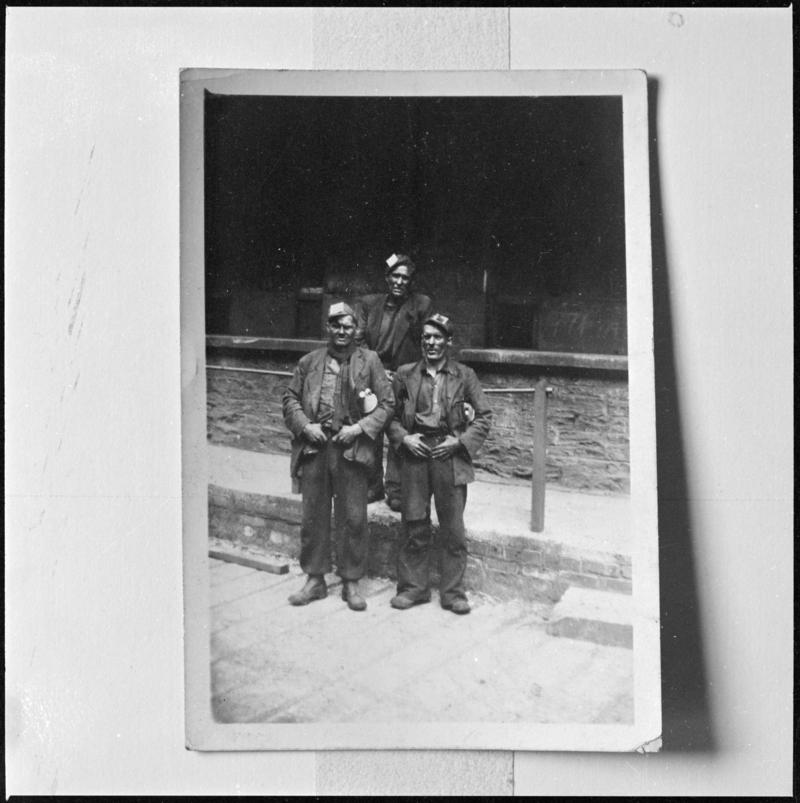Black and white film negative of a photograph showing three miners, Deep Navigation Colliery.  'Deep Navigation' is transcribed from original negative bag.