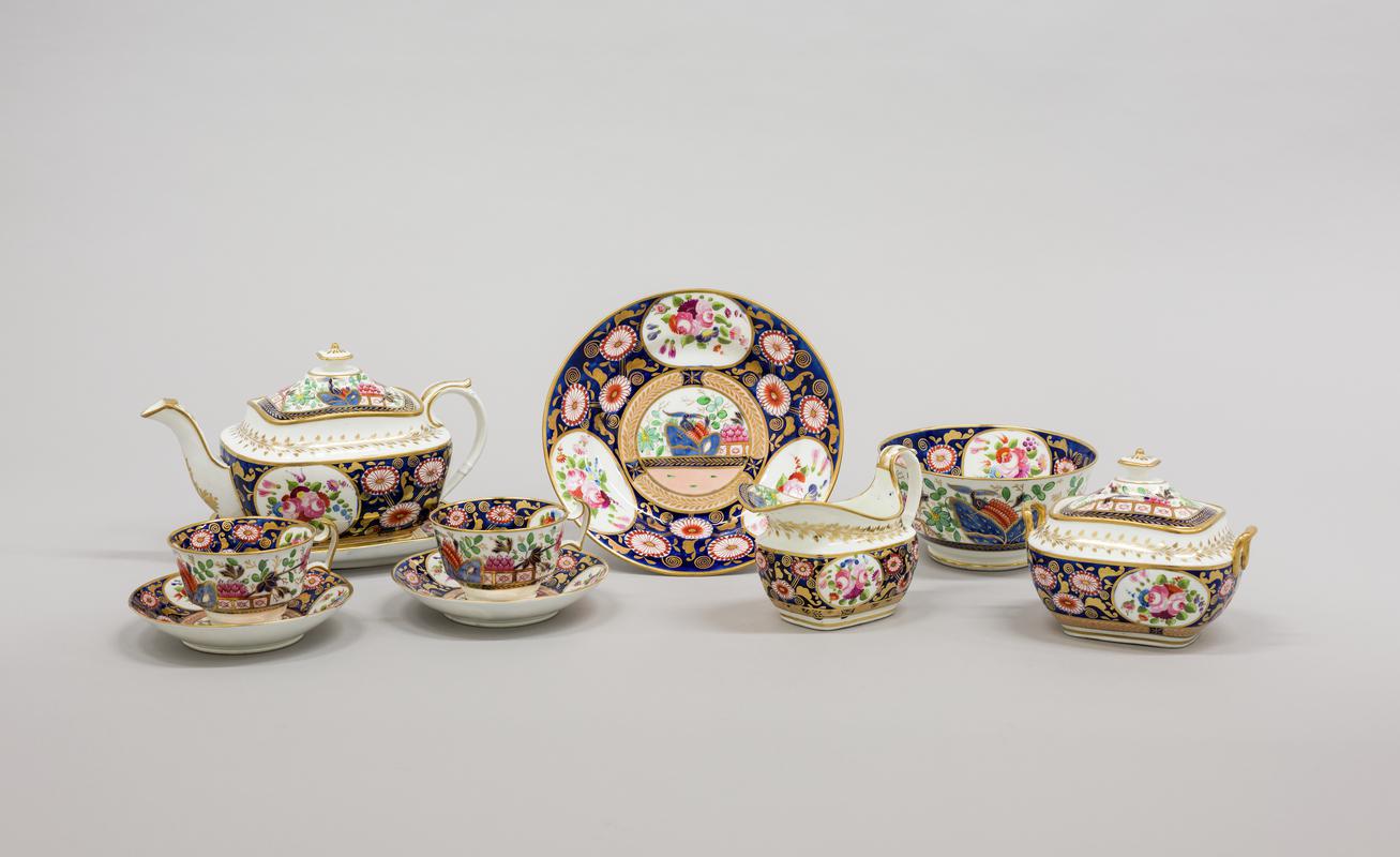 porcelain teapot & stand, porcelain cream jug, porcelain slop bowl, porcelain sugar box & cover, porcelain plate, 2 x porcelain cup & saucer - Group shot