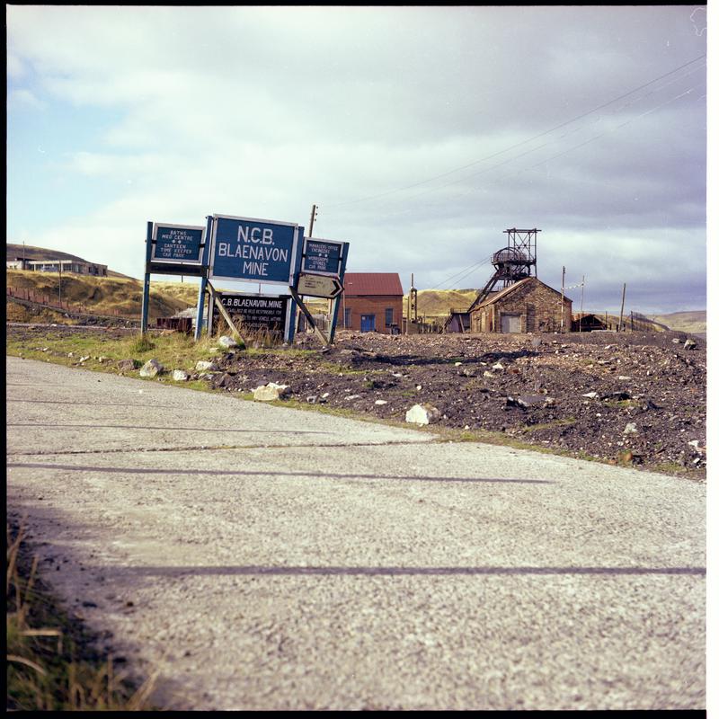 Colour film negative showing an 'NCB Blaenavon Mine' sign with headgear in the background.