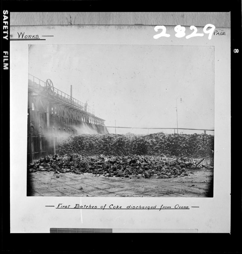 Black and white film negative of a photograph showing the 'First Batches of Coke Discharged from Ovens' at the new Maritime Coke Ovens, 1903.