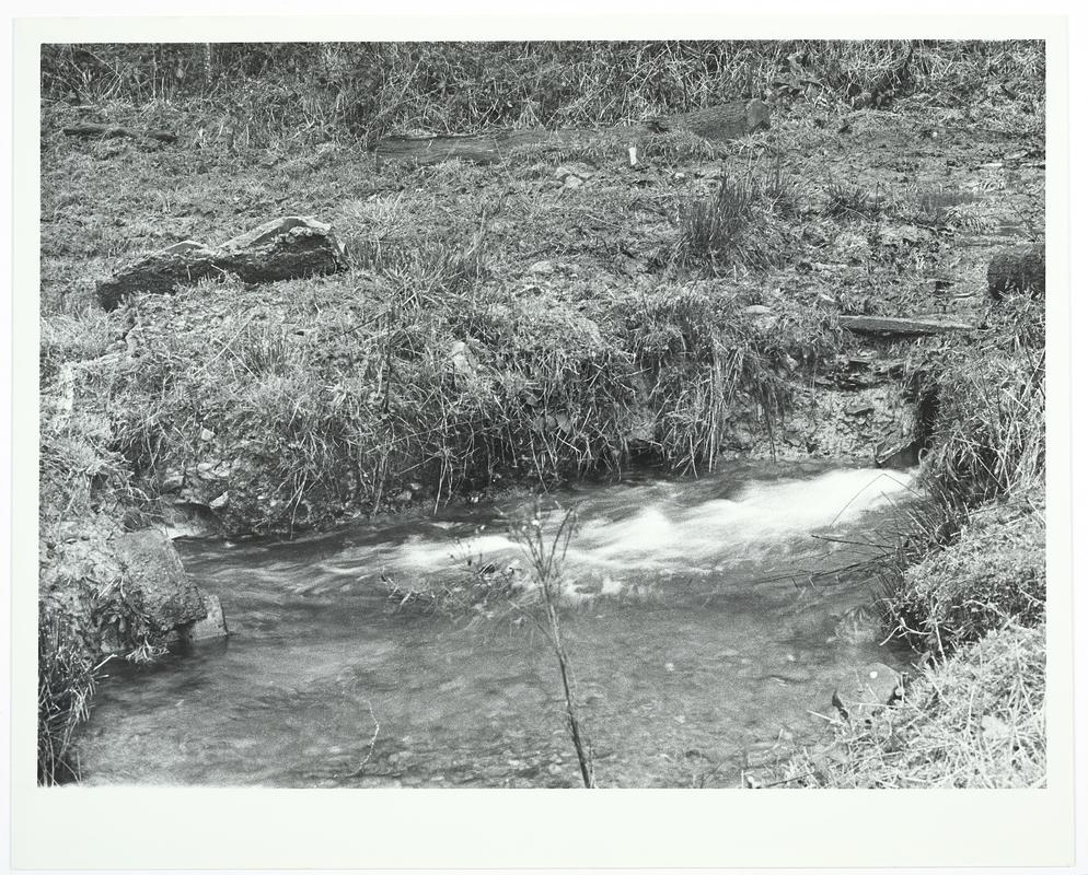 Photograph showing the break in the supply to riser of overshot waterwheel at Dolaucothi, 27 December 1973.