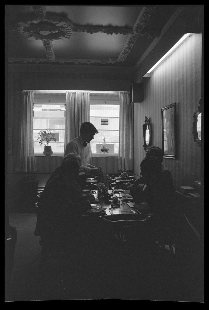 Waiter serving people in Exchange restaurant.