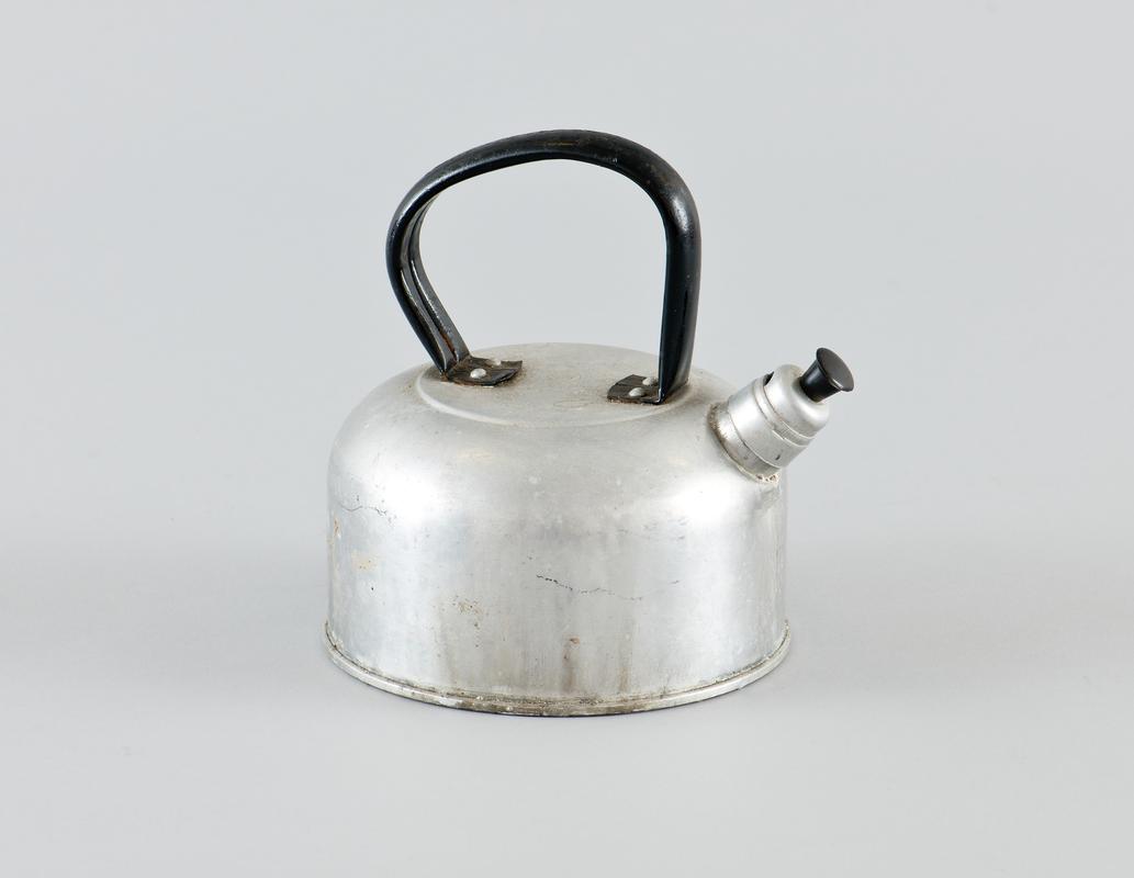 Aluminium sealed kettle, filled through spout. Plastic handle for spout stopper. Instructions die stamped on top of kettle.