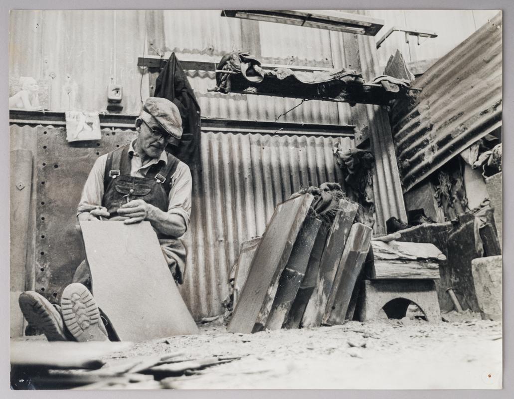 Photographic Print of a Quarryman splitting slate.
