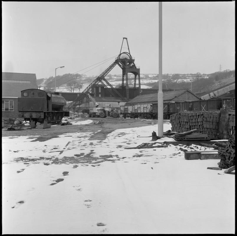 Black and white film negative showing a NCB steam locomotive in the Lady Windsor Colliery yard with the upcast shaft in the background, 1977.