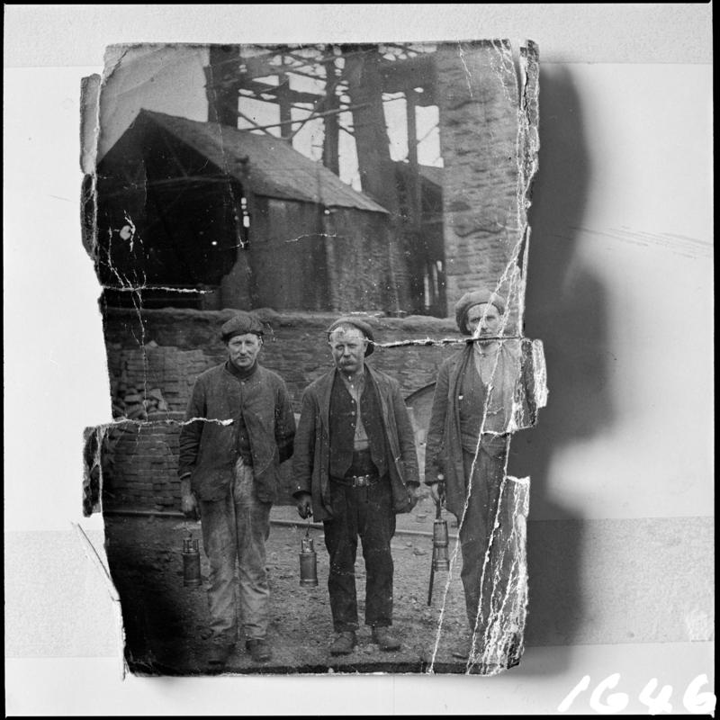 Black and white film negative showing three workmen at Deep Navigation Colliery.