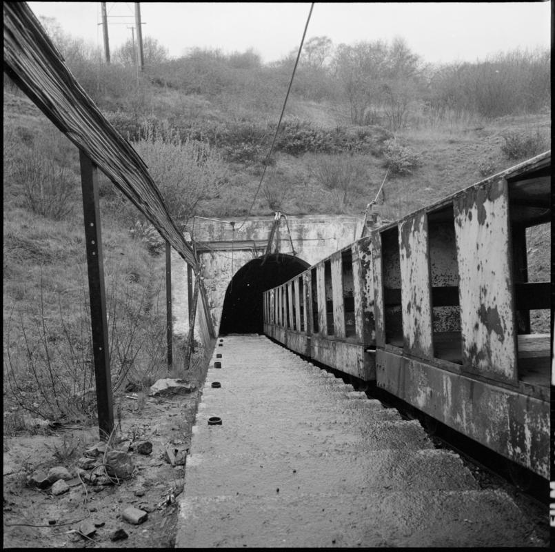 Black and white film negative showing the manriding train at the entrance of the mine, Cwmgwili Colliery.  'Cwmgwili' is transcribed from original negative bag.