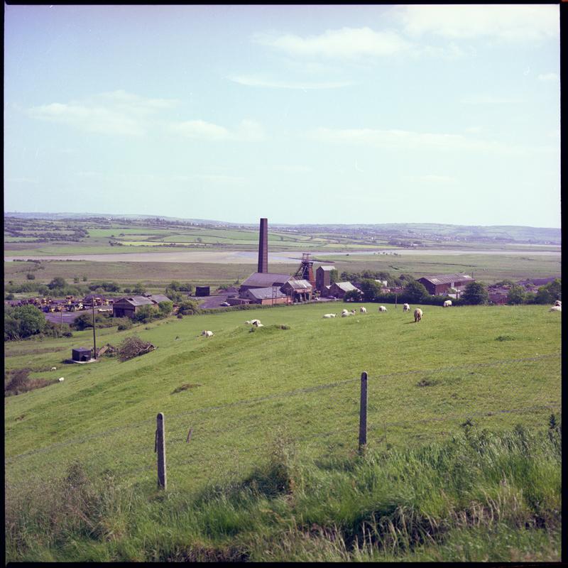 Colour film negative showing a distant surface view of Morlais Colliery. 'Morlais' is transcribed from original negative bag.