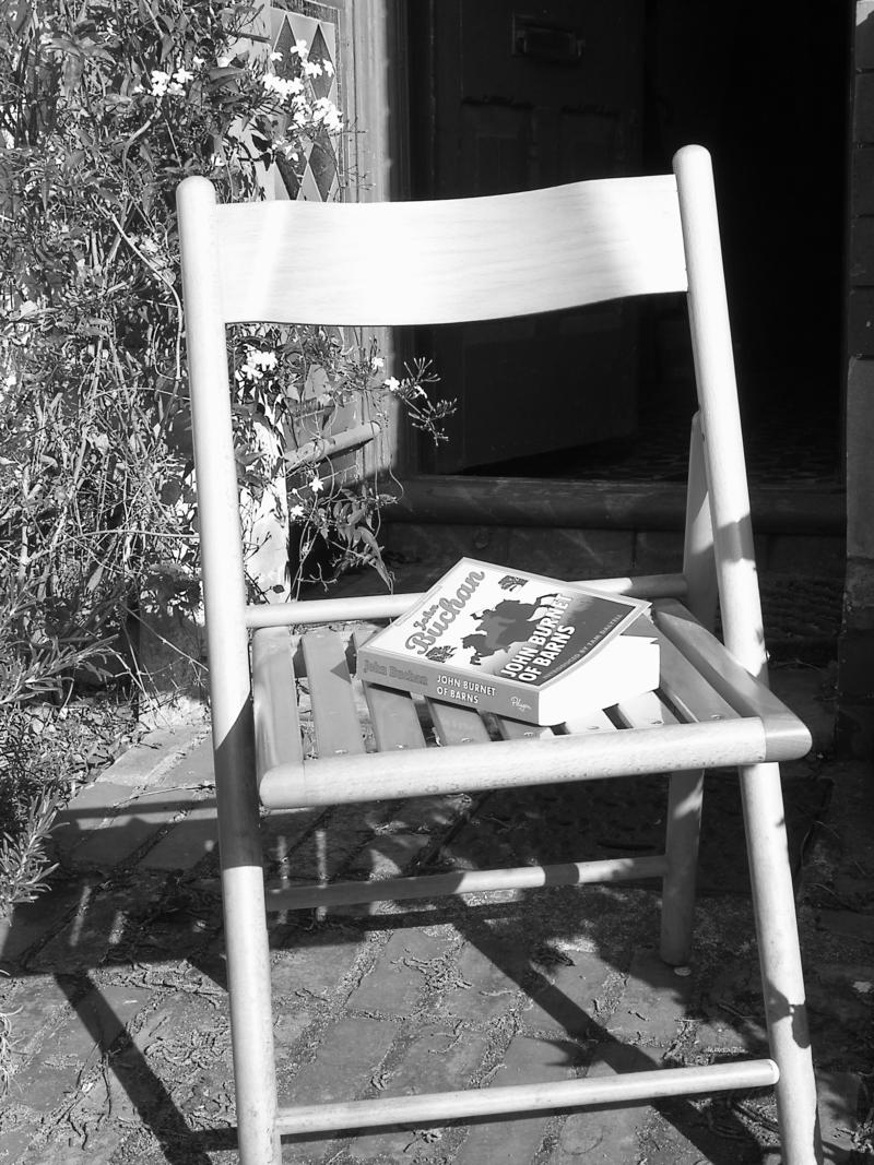Chair and book in front of the house to catch the evening sun.