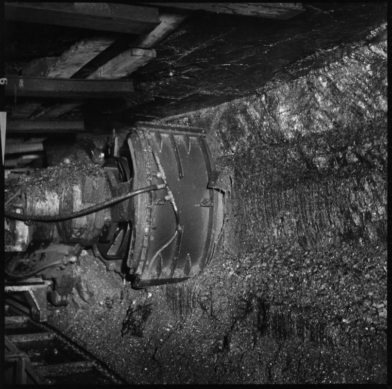 Black and white film negative showing a shearer on the coal face, Tymawr Colliery 21 December 1976.  'Face Ty Mawr 21/12/76' is transcribed from original negative bag.