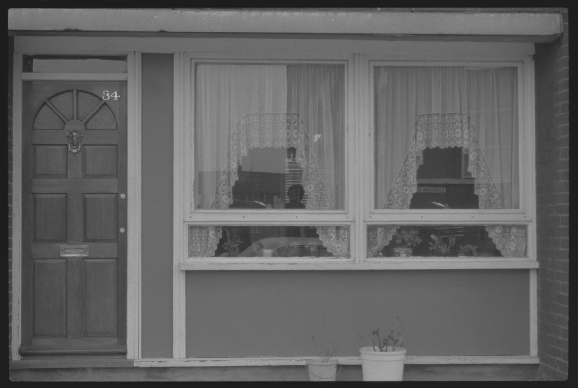 Front of house, bottom story at Loudoun Square, Butetown. Owner having replaced front door.