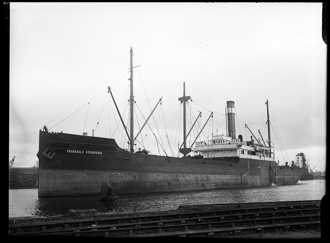 Three quarter Port bow view of S.S. FRANGOULA VRONDISSIS and waterman's boat, c.1936.
