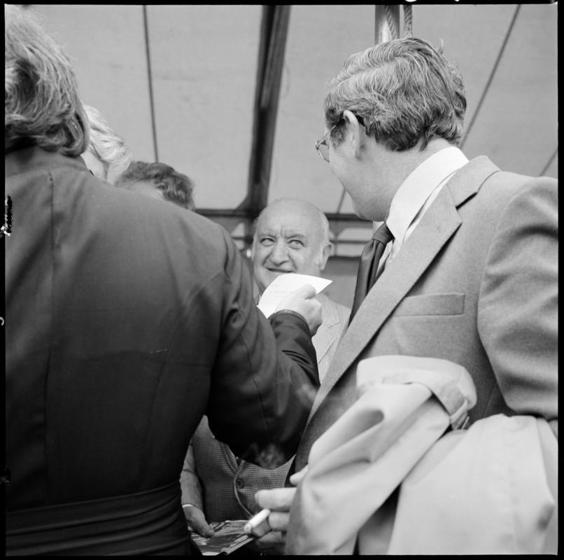 Black and white film negative showing the unveiling ceremony of the Senghenydd memorial, commemorating the 1913 Universal Colliery explosion.  The negative is undated but the ceremony took place in October 1981. 'Senghenydd' is transcribed from original negative bag.