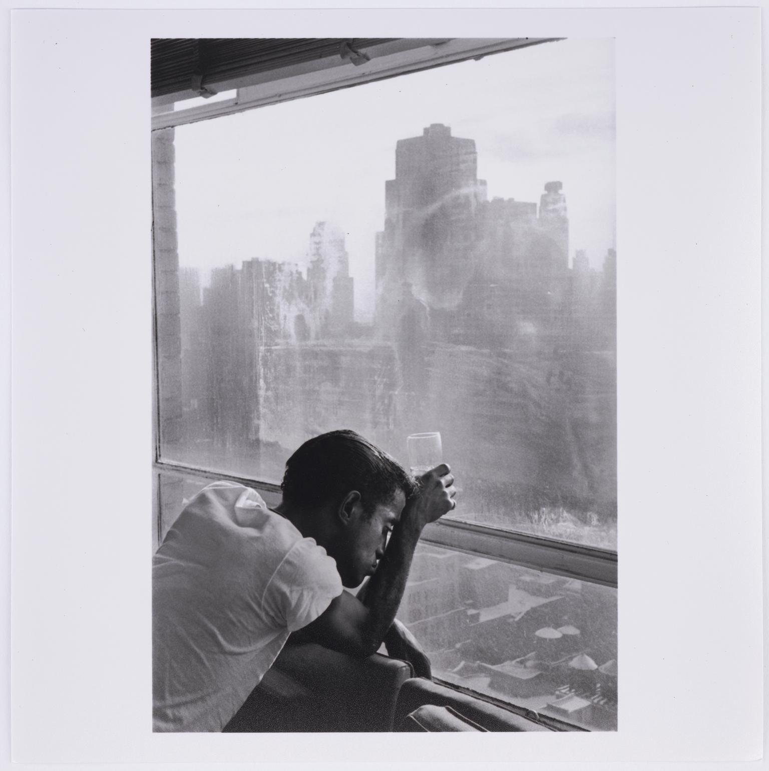 Sammy Davis Jr. looks out a Manhattan window, New York City