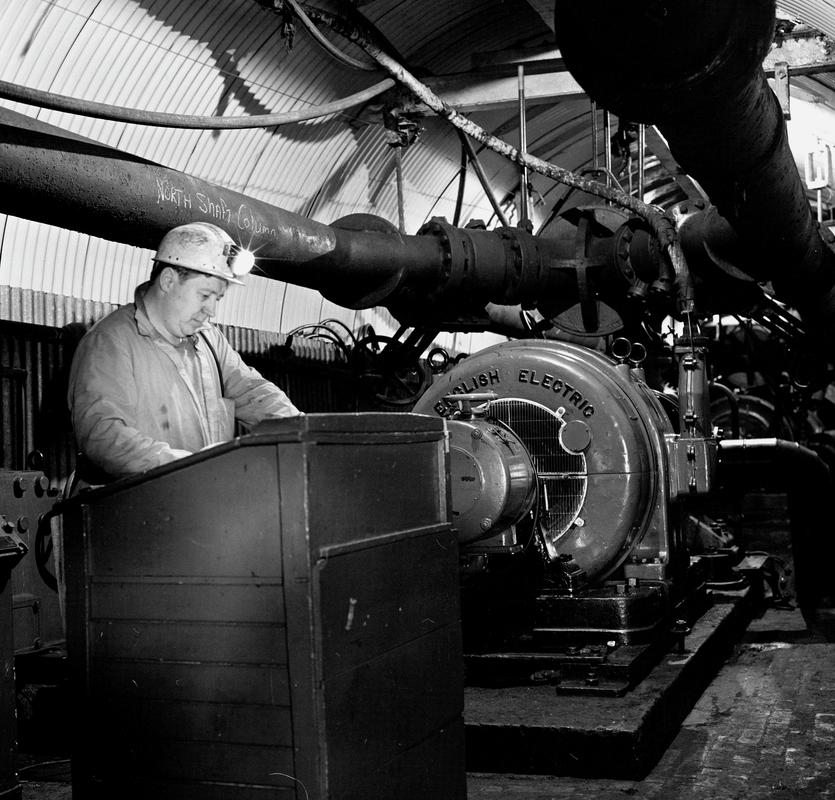 Black and white film negative showing a man operating the 'English Electric' engine, Oakdale Colliery, May 1980.  'Oakdale May 1980' is transcribed from original negative bag.
