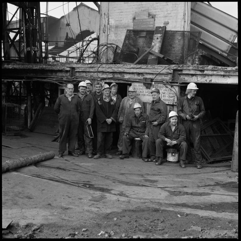 Black and white film negative showing a group of miners at pit top, Deep Duffryn Colliery, 15 April 1980.  'Deep Duffryn 15/4/80' is transcribed from original negative bag.