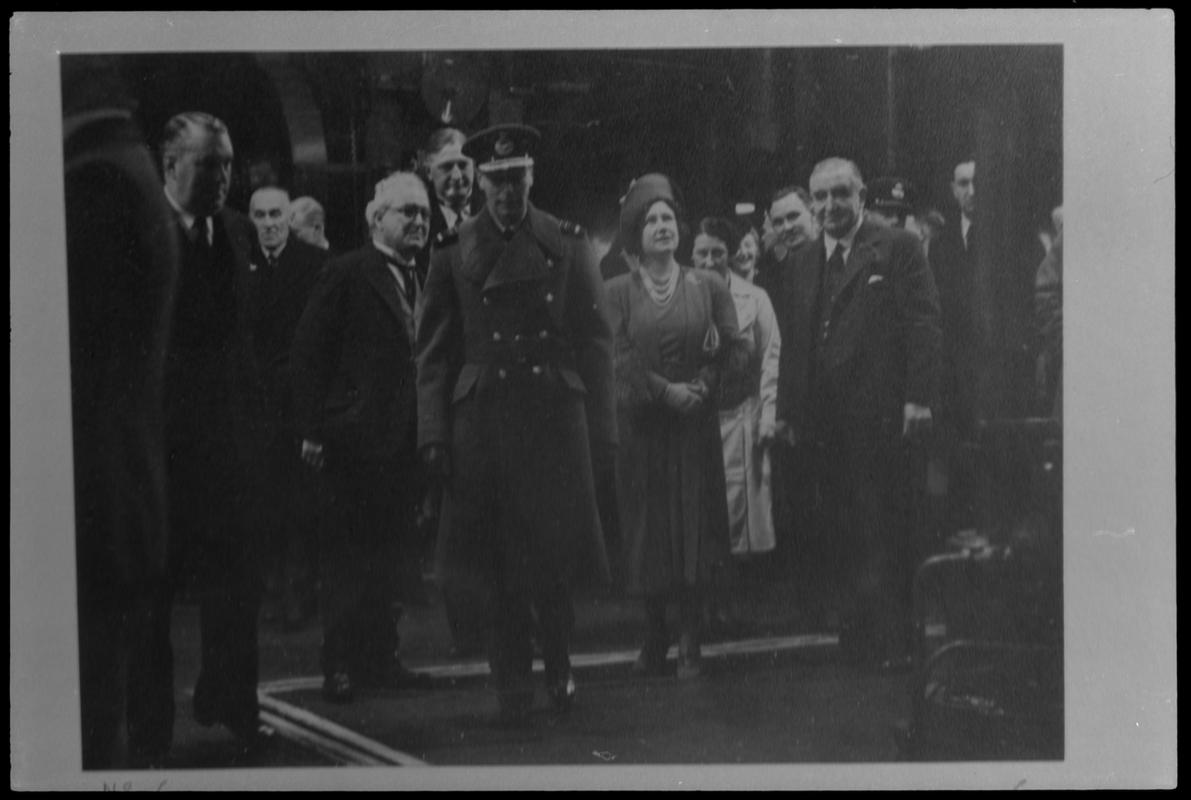 Film negative of a photograph showing visit of King George VI, Queen Elizabeth and other dignitaries to Currans, Butetown during World War II.