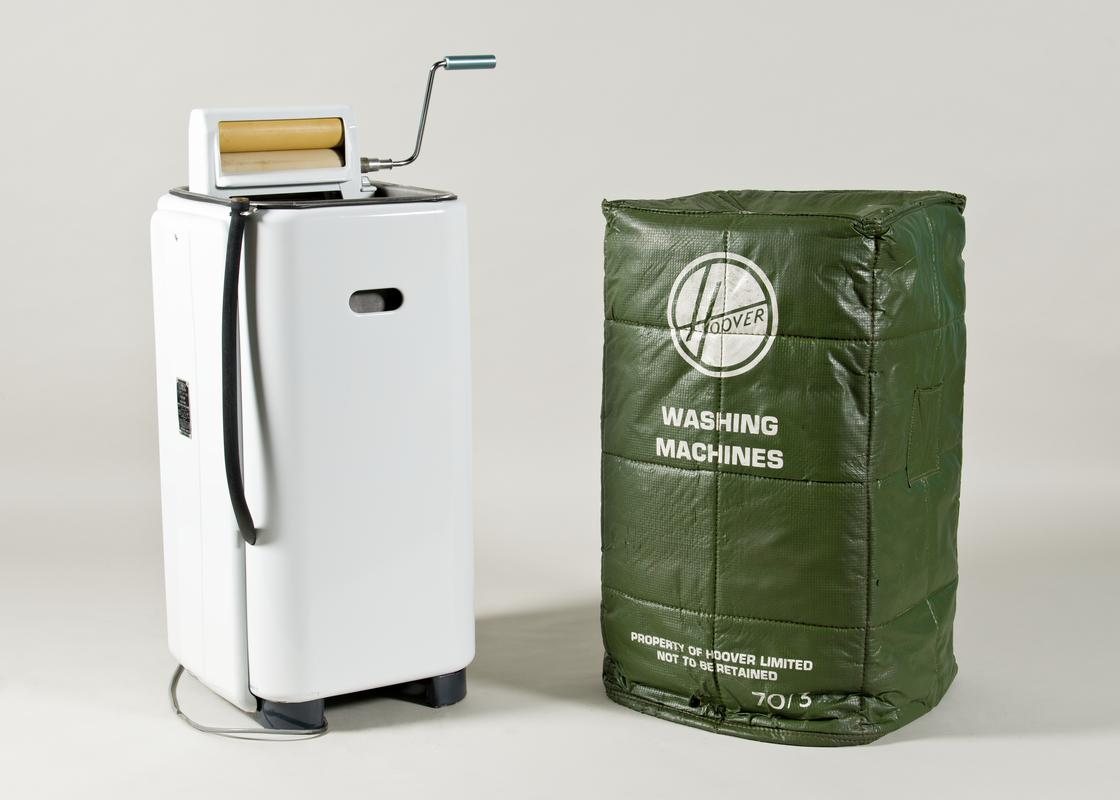 Hoover electric washing machine (2008.1/1) with integral wringer/mangle that folds inside. With 'Protectomuffs' cover (2008.1/2) for Hoover washing machine . Green with white lining. Inscription printed in white on one side.