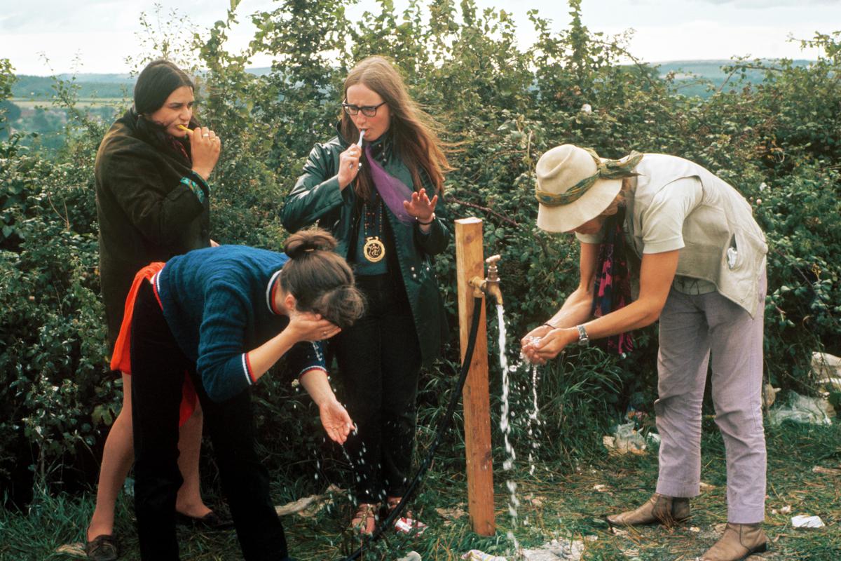 GB. ENGLAND. Isle of Wight Festival. Water is provided for washing. Although cold, it is a friendly communal affair. 1969.