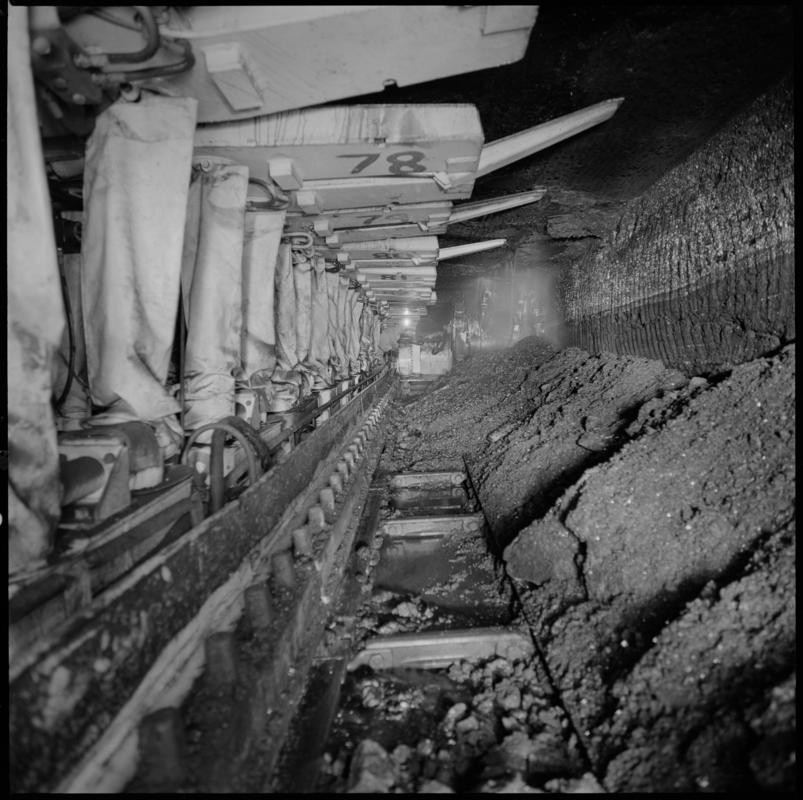 Black and white film negative showing chainless haualge on the face with Gullick Dobson powered supports, Betws Mine.  'Betws' is transcribed from original negative bag.