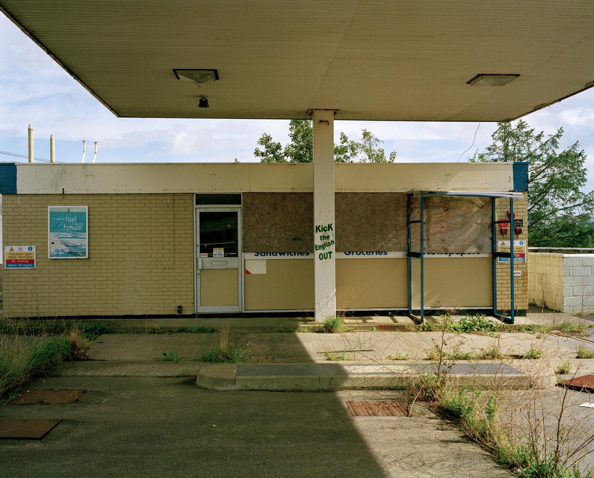 Abandoned petrol station. Welsh politics. Building aside the A40, Wales