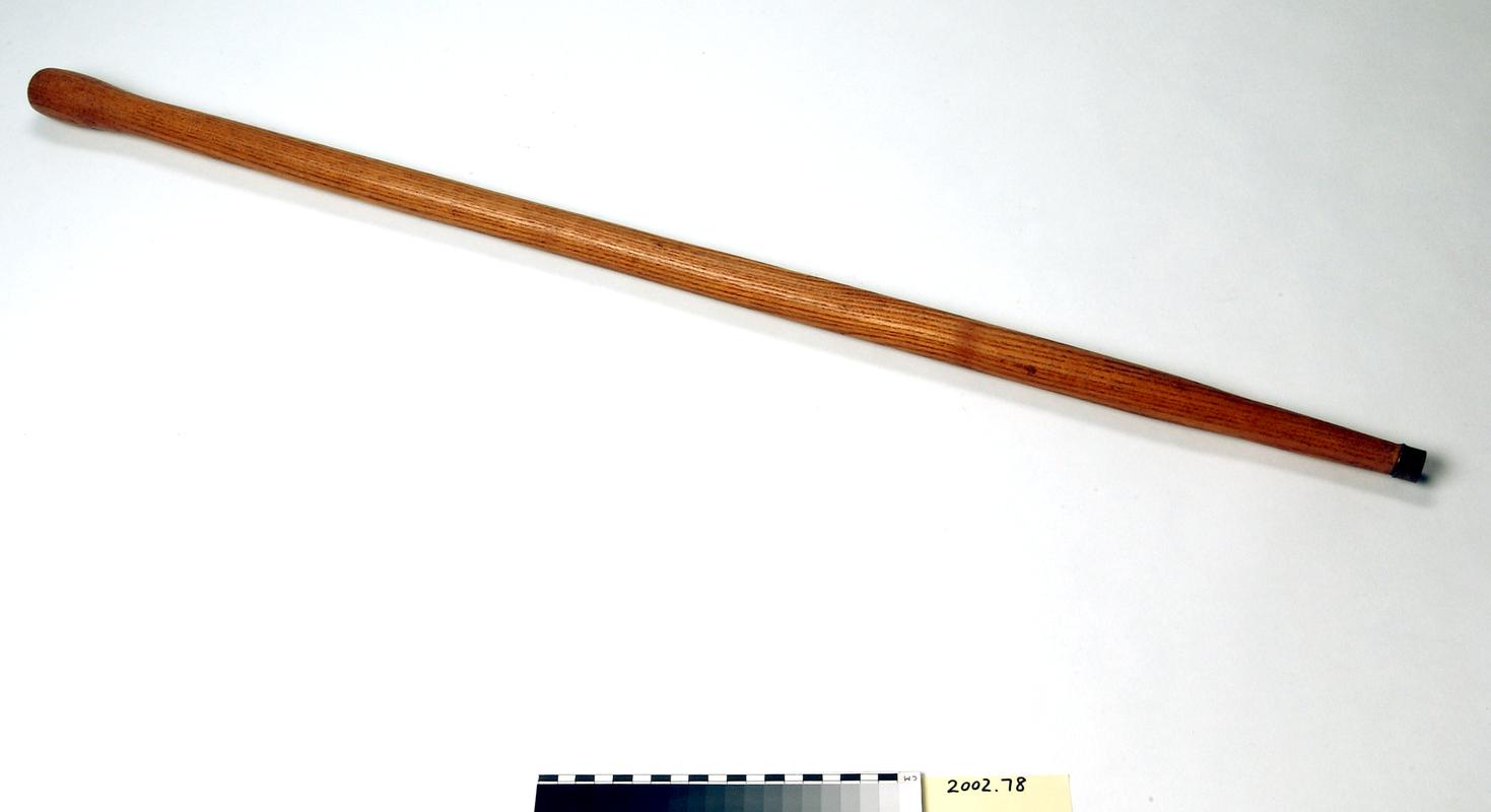 Wooden Deputy's yardstick with metal tip.