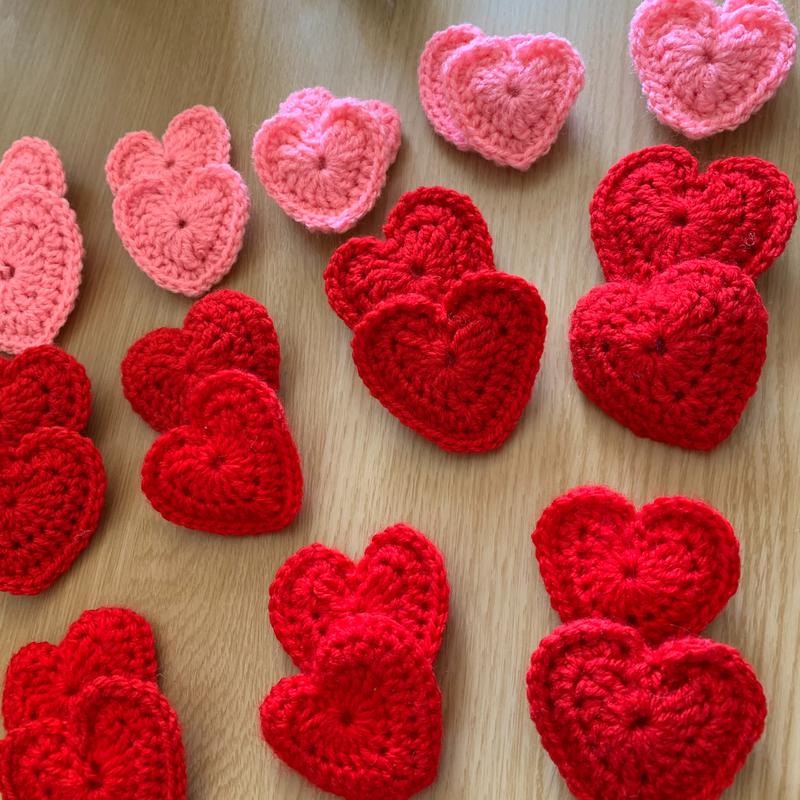 Crocheted red hearts made after an appeal from Yorkshire NHS, a heart is given to the patient, their family who cant visit get matching heart, they are all made in pairs.