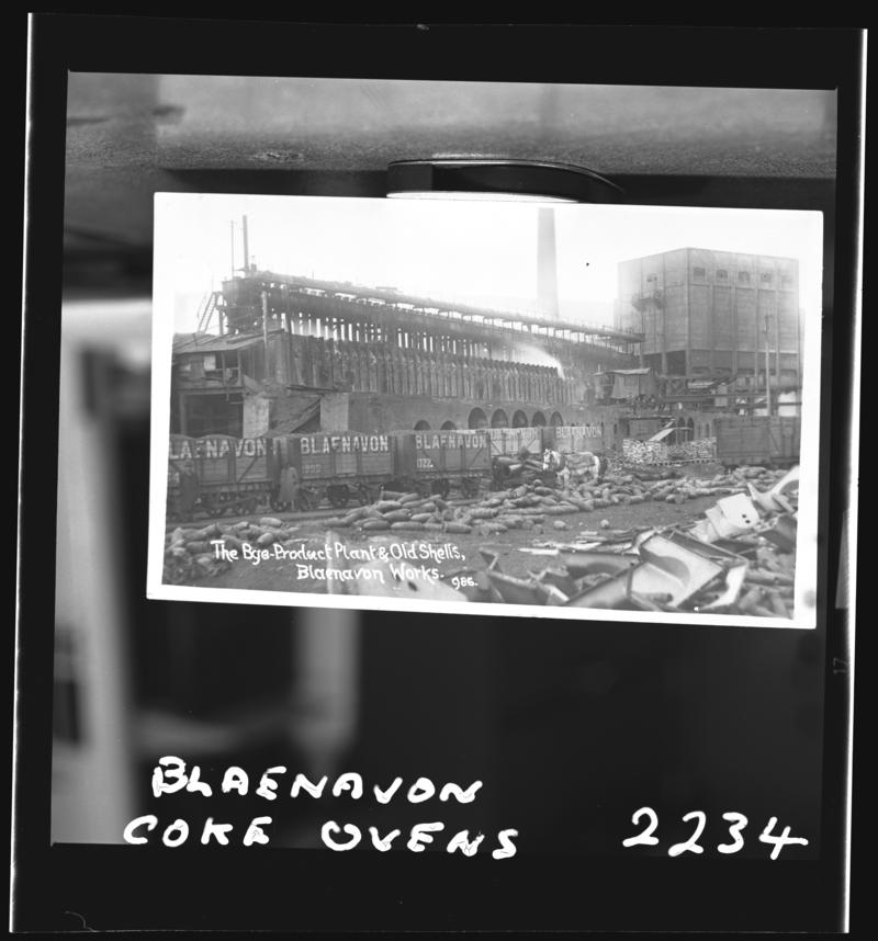 Black and white film negative of a photograph showing the Blaenavon coke ovens. Caption on photograph states 'The bye-product plant and old shells, Blaenavon works'.
