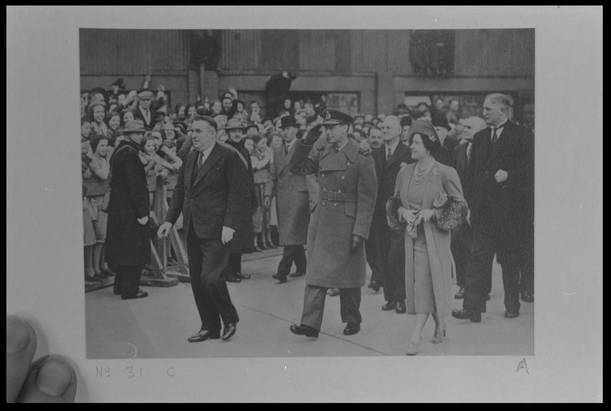 Film negative of a photograph showing visit of King George VI and Queen Elizabeth to Currans, Butetown during World War II.