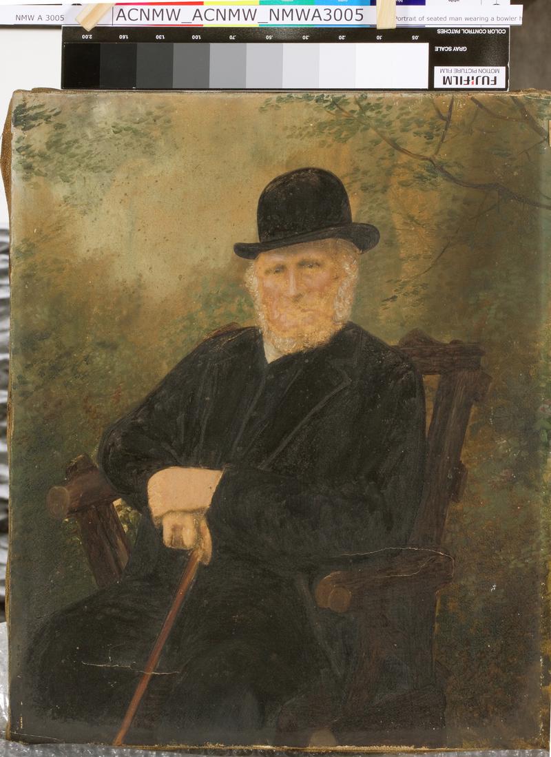 Portrait of seated man wearing a bowler hat