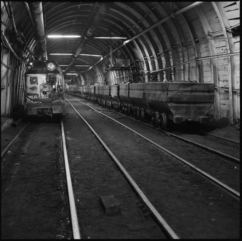 Black and white film negative showing drams and an electric locomotive underground at Penallta Colliery.