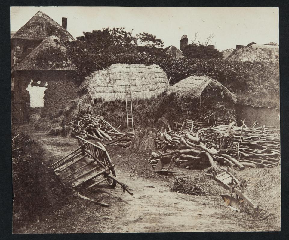 Hay stacks in farmyard, photograph